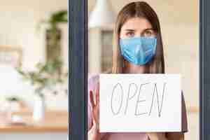 Free photo front view of woman with open sign