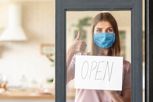 Front view of woman with open sign