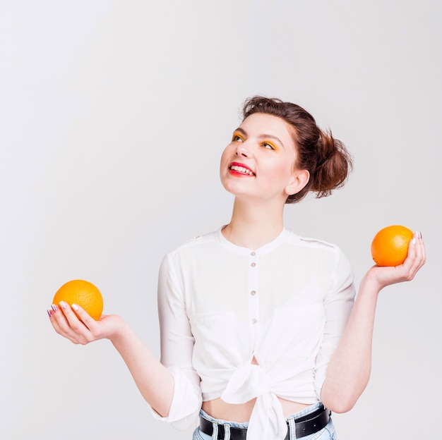 Front view of woman with oranges