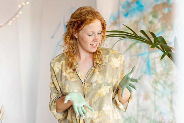 Front view woman with paint on palms