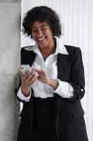 Free photo front view woman with smartphone laughing