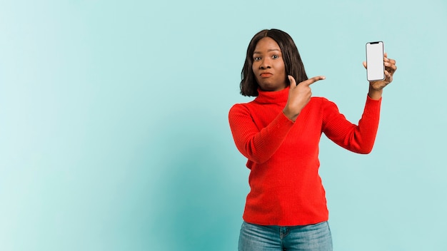 Front view woman with smartphone in studio