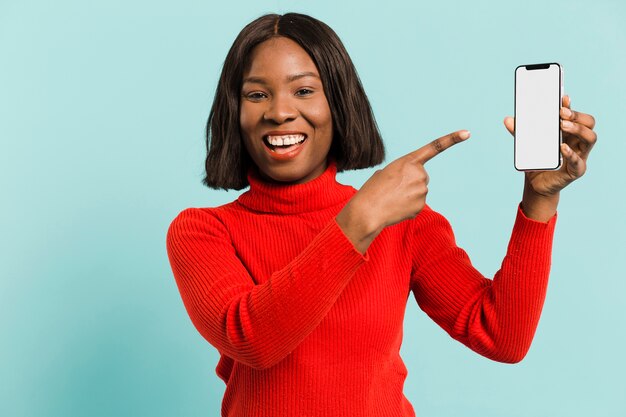 Front view woman with smartphone in studio