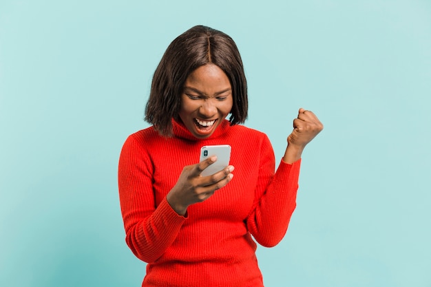 Front view woman with smartphone in studio