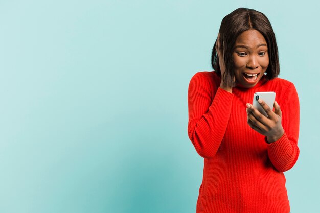 Front view woman with smartphone in studio