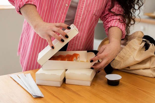 Front view woman with sushi box
