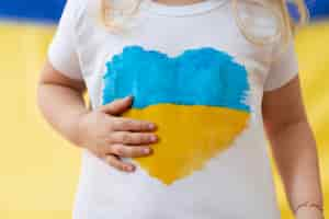 Free photo front view woman with ukranian flag shirt