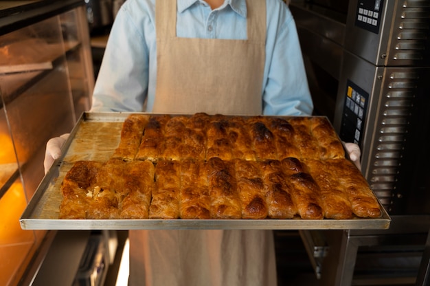 Free photo front view woman working in bakery