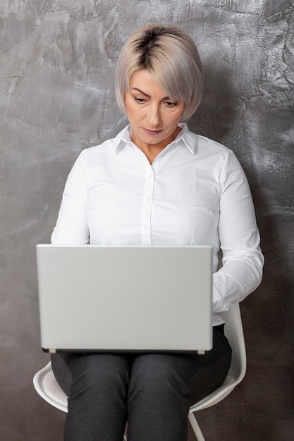 Front view woman working on laptop