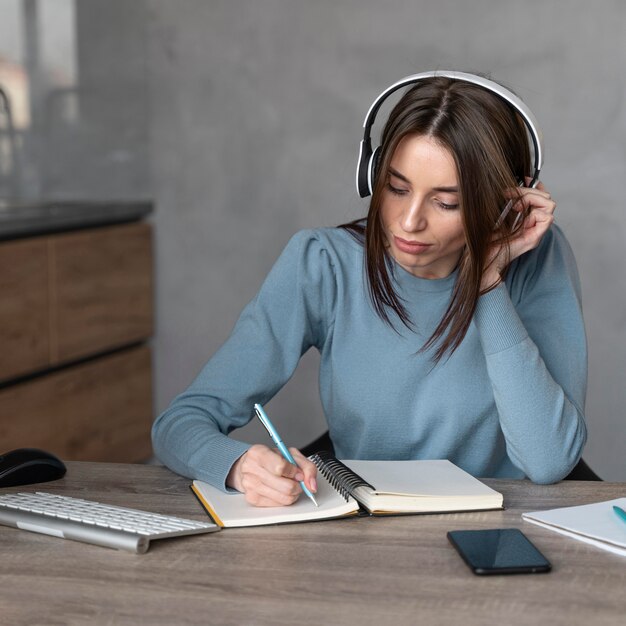 Front view of woman working in the media field with headphones