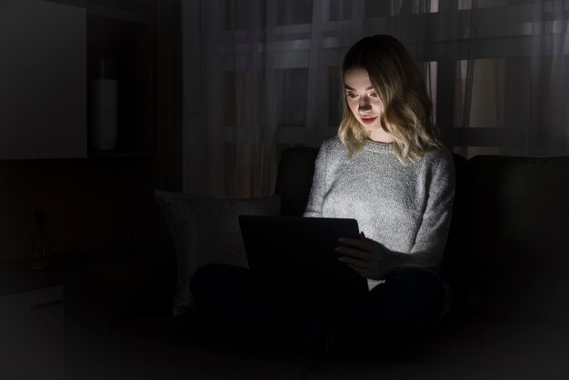 Front view of woman working at night