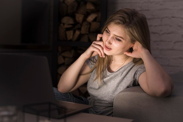 Front view of woman working at night