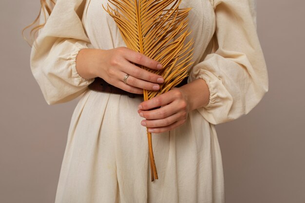 Front view woman working with dried plant