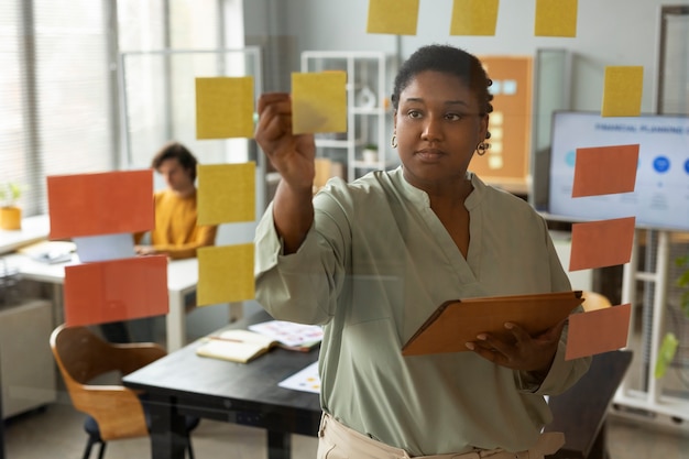 Front view woman working with post its