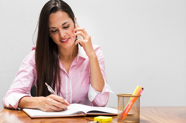 Front view woman writing statistics