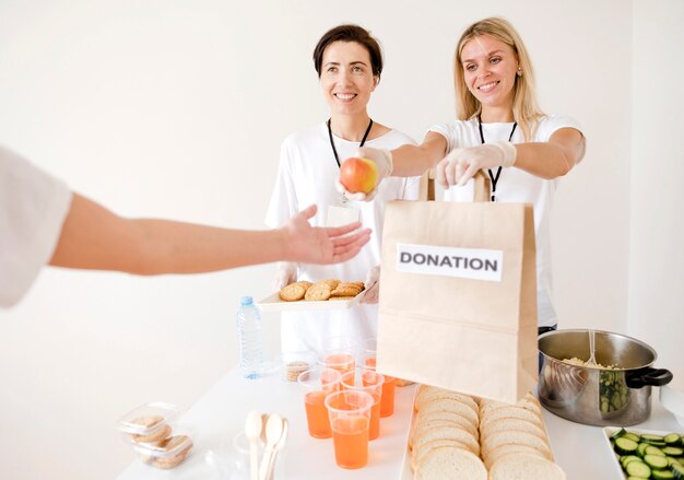 Front view of women donating food