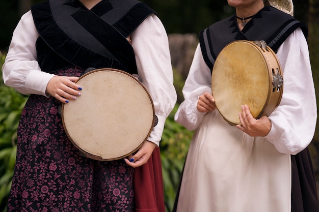 Front view women holding tambourines