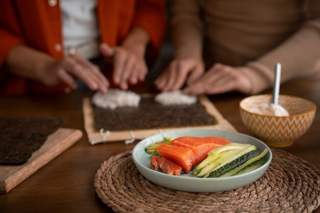 Free photo front view women learning to make sushi