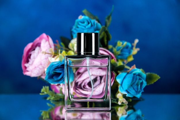 Free photo front view of women perfume colored flowers on dark blue