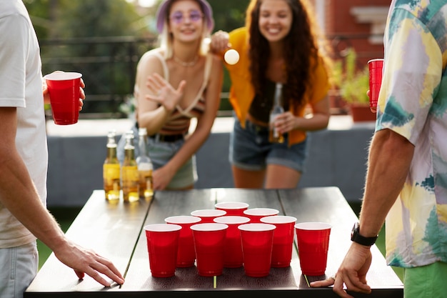 Front view women playing beer pong