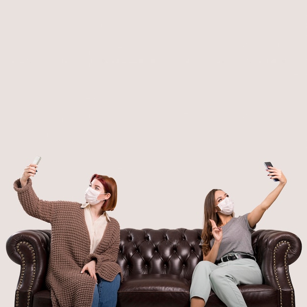 Front view of women sitting on sofa