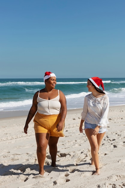 Front view women walking on beach