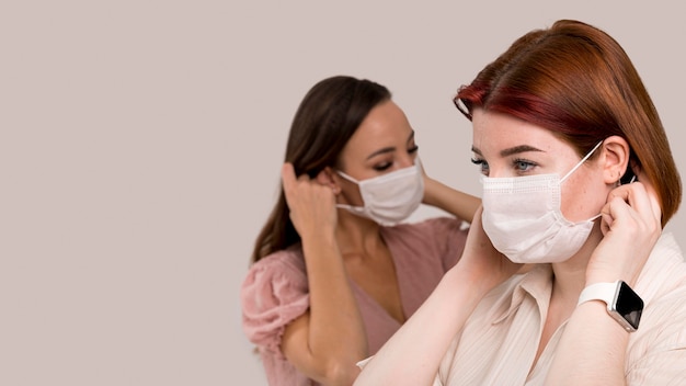 Free photo front view of women with face mask