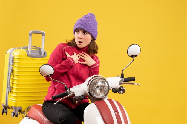 Front view wondered young woman on moped looking at something