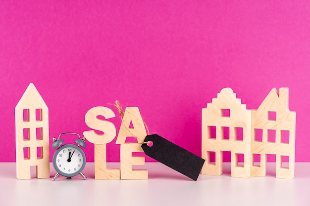 Front view wooden sale lettering next to wooden houses