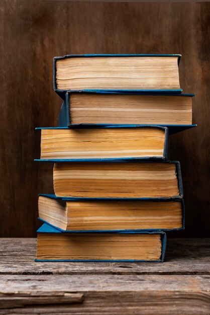 Front view of wooden table with stacked books