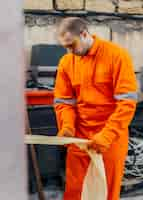 Free photo front view of worker in uniform with safety glasses