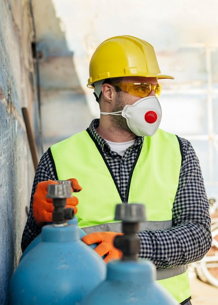 front view of worker with protective mask and hard hat