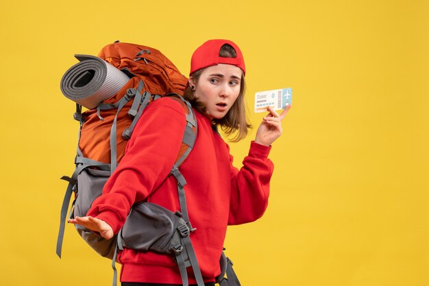 Front view worried female backpacker holding air ticket