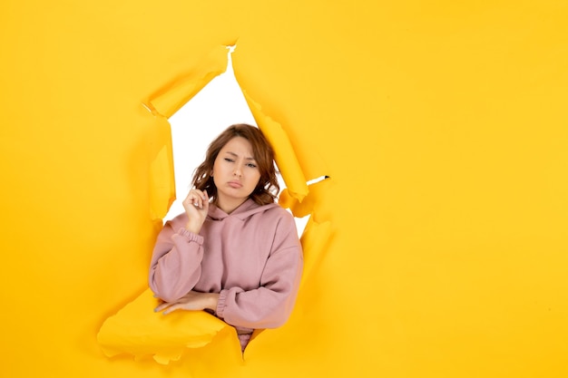 Free photo front view of worried woman thinking deeply and free space on yellow torn