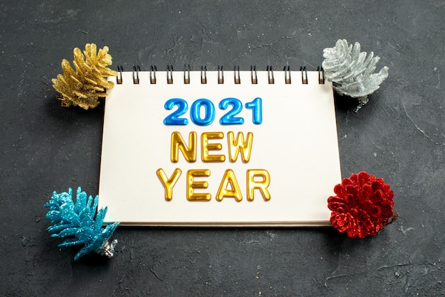 Free photo front view writing with new year writing in notepad