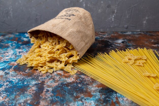 Front view yellow raw pasta on desk