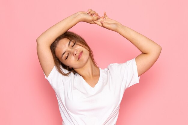 A front view young beautiful female in white shirt posing with resting expression