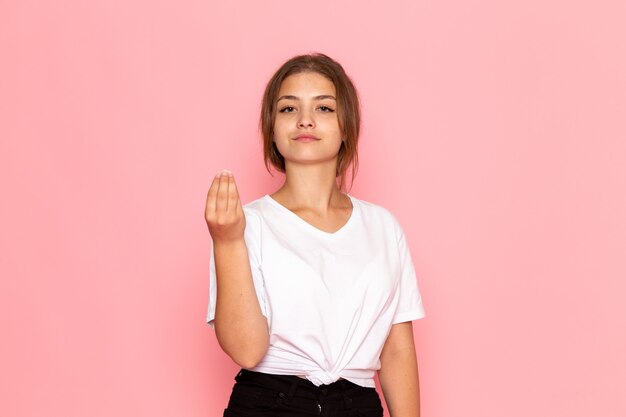 A front view young beautiful female in white shirt posing