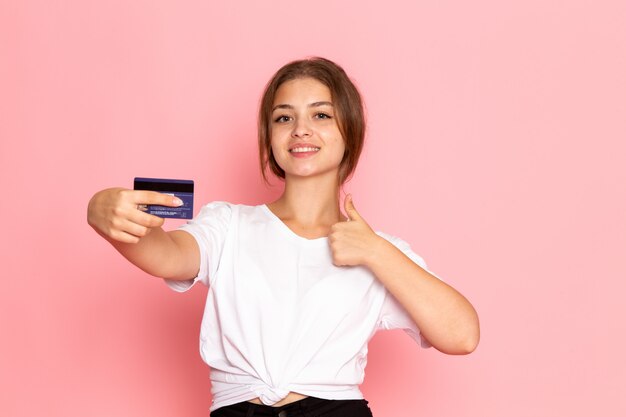 A front view young beautiful female in white shirt with holding purple card