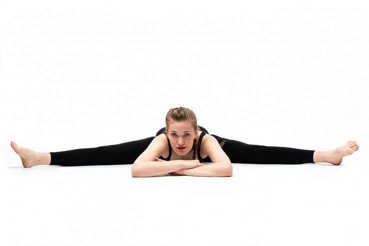 Free Photo a front view young beautiful girl in black-flamed sport shirt and black trousers posing doing gymnastics in different poses on the white