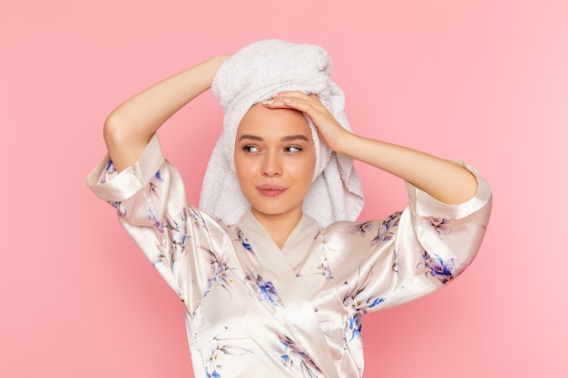 Free photo a front view young beautiful lady in bathrobe drying her hair