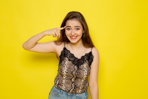 A front view young beautiful lady in brown blouse and blue jeans smiling