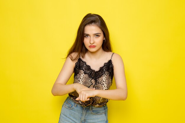 A front view young beautiful lady in brown blouse and blue jeans with angry expression