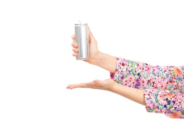 Free photo a front view young beautiful lady in colorful flower designed shirt holding silver can showing open palm on the white