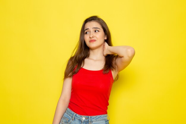 A front view young beautiful lady in red shirt and blue jeans with stressed expression model girl color female