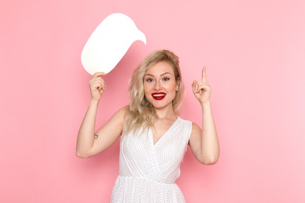 A front view young beautiful lady in white dress holding white sign