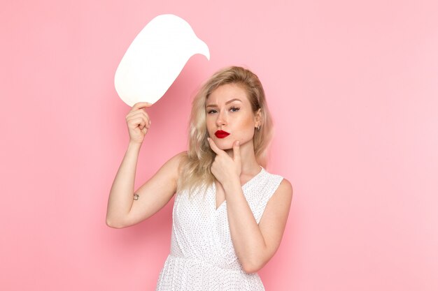 A front view young beautiful lady in white dress holding white sign