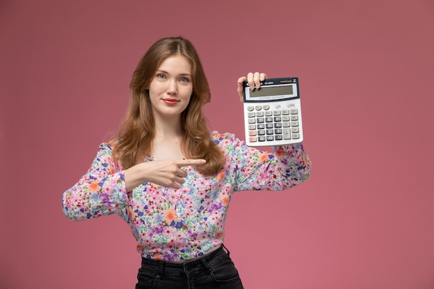 Free photo front view young blonde demonstrates her calculator