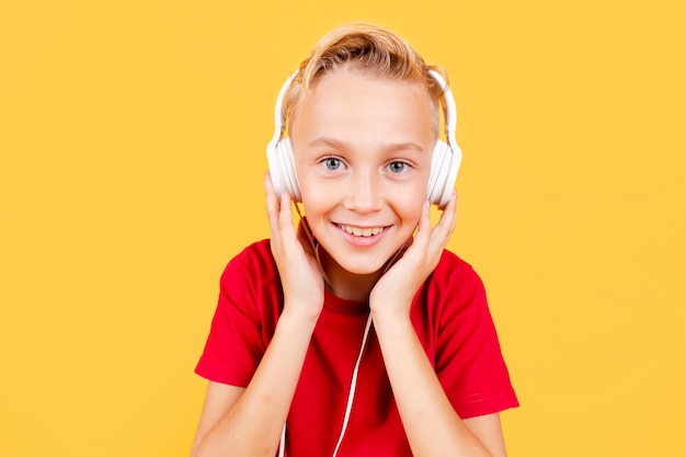 Free photo front view young boy listening music