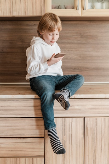 Free photo front view of young boy using smartphone